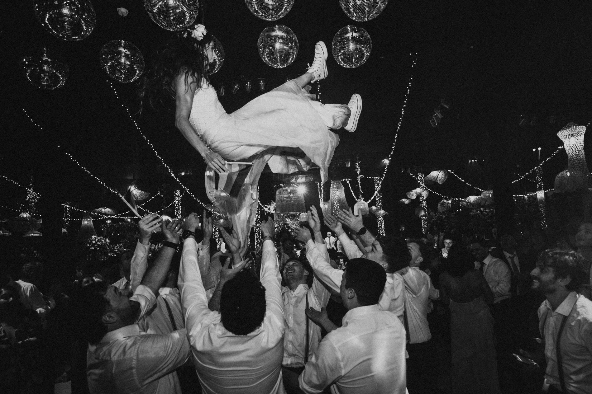 Bride lifted above the crowd on the dance floor